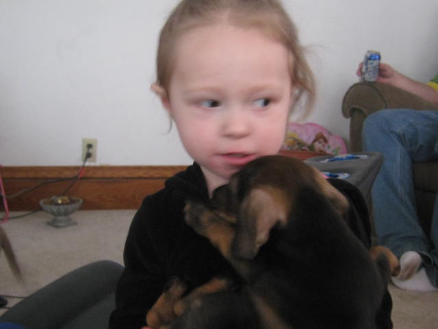 Our friend's daughter and Pepper the first week we had him. Super Bowl Sunday