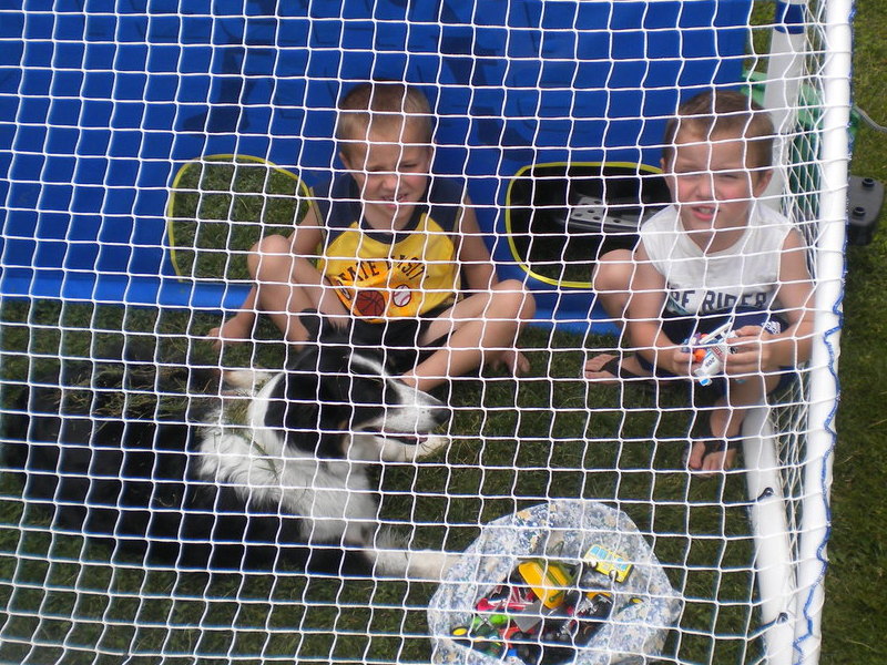 in the goal with her two little boys