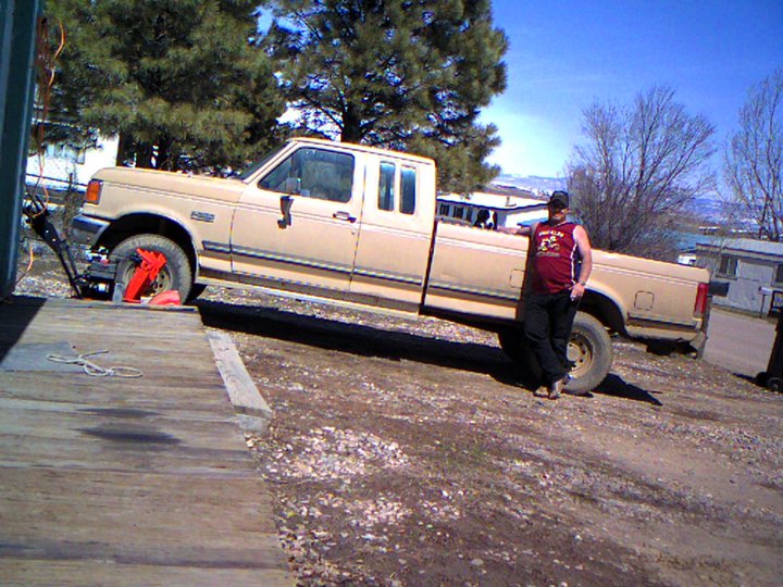 lady in the back of the truck next to her owner